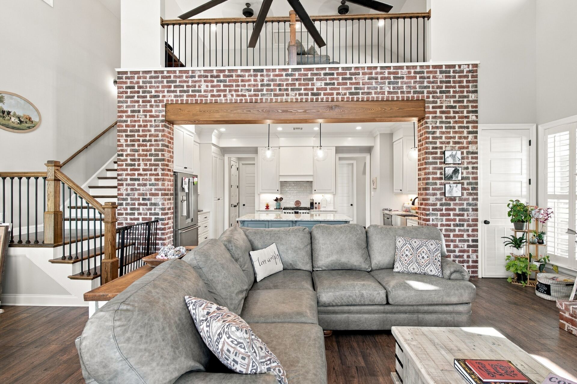 Living area with exposed brick wall and sectional sofa