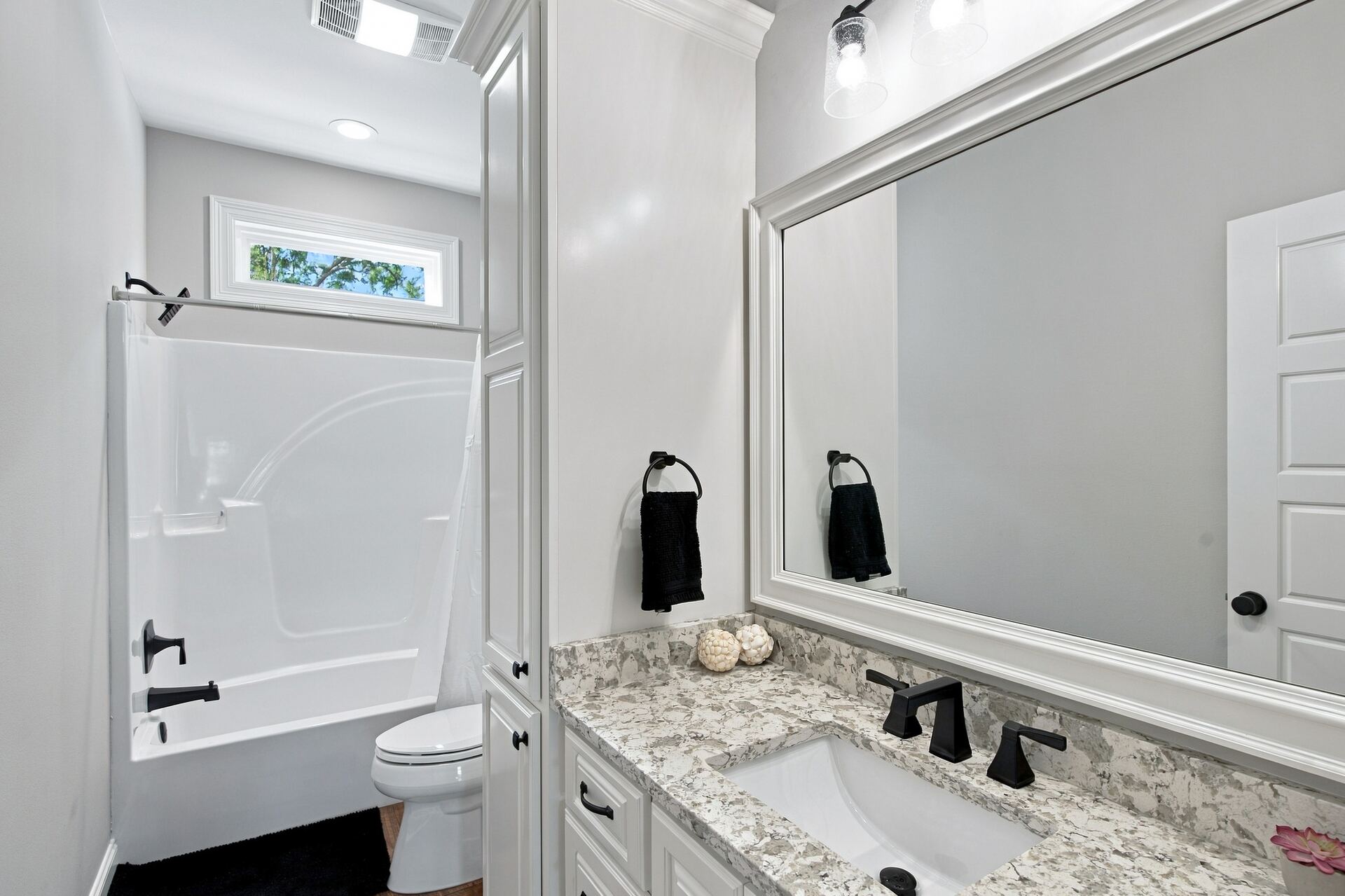 Guest bathroom with tub, shower and granite vanity